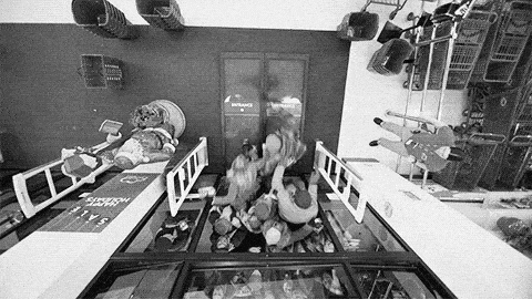 Black and white video from what appears to be a shop-surveyllance-camera showing people fighting to get inside a super market.